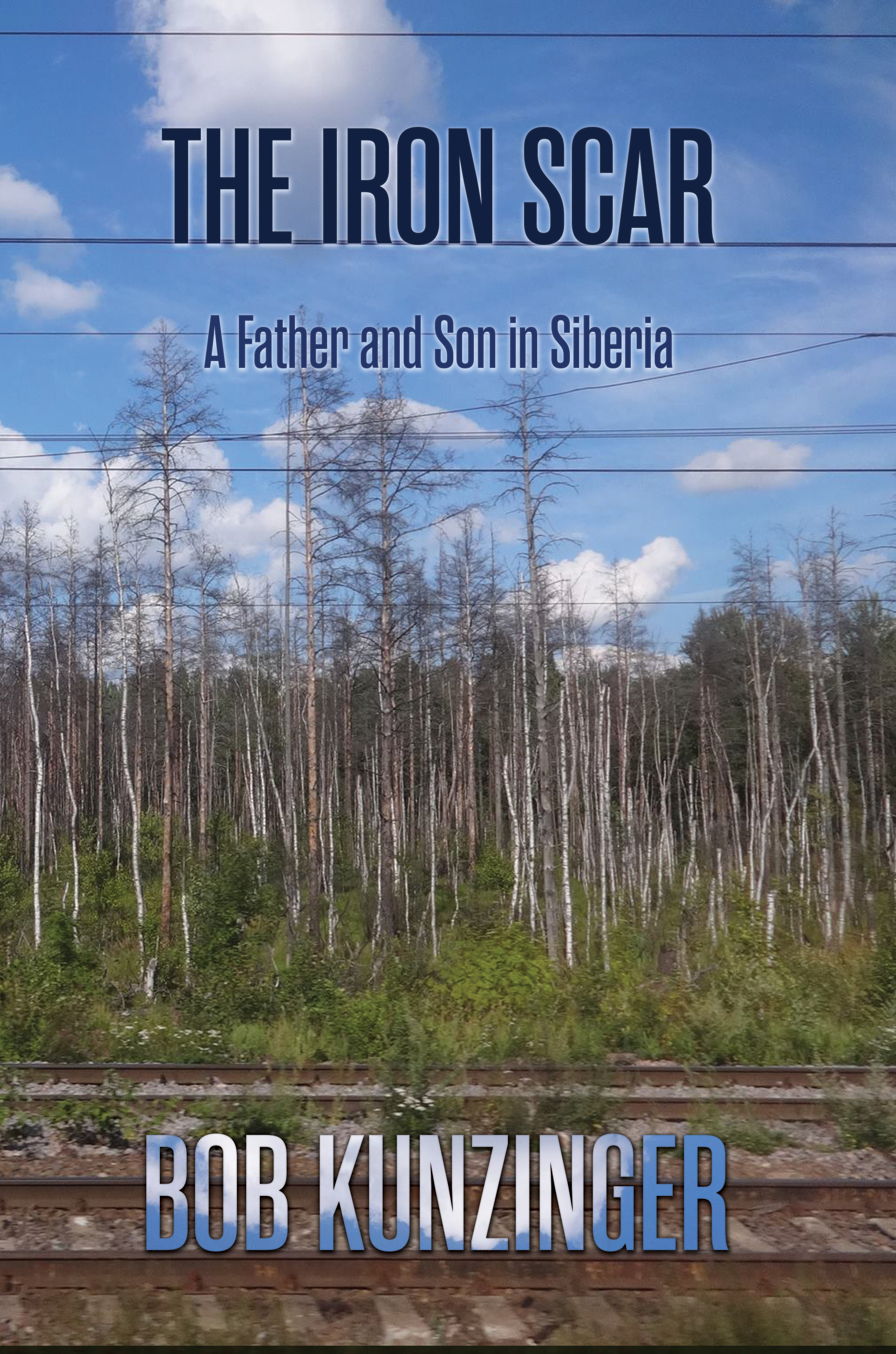 The Iron Scar: A Father and Son in Siberia by Bob Kunzinger with photos by Michael Kunzinger. Image shows a young forest along the tracks with a bright blue sky above