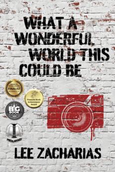 What a Wonderful World This Could Be by Lee Zacharias shows a white painted brick wall with a red camera in the style of Banksy spray painted on the brickwork. The cover also displays four medallions for awards the book has won.