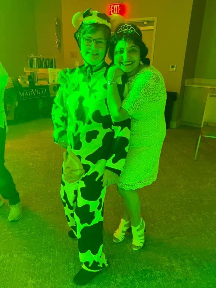 Anju Gattani (Dynasties) poses with a bookclub member dressed as a cow during the "Hair Ball."