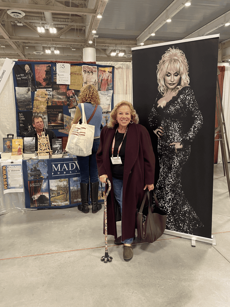 Author Francine Rodriguez gets a photo with the Dolly poster at the AWP Book Fair.