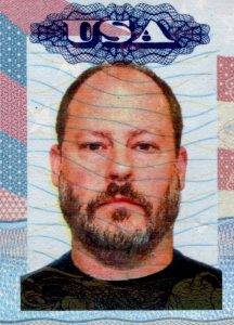 A passport photo, in color, of author Sean D. Carberry. Above his head is the familiar USA emblam emblazened across the top of the photo. Credit goes to CVS Pharmacy.