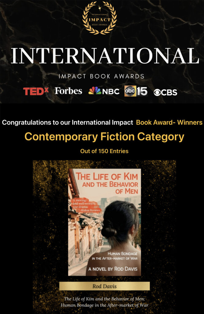 Announcement that The Life of Kim and the Behavior of Men has won an International Book Award. It's black with mostly gold lettering and shows the book cover.
