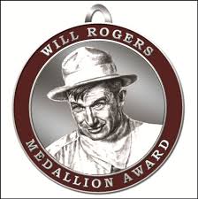 Official Will Rogers Medallion Award. With a half-tone rendering of Rogers himself set into a circle of maroon with beige letters around the edge.