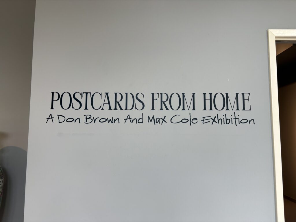 The art opening at the Michelson Museum was titled "Postcards from Home: A Dan Brown and Max Cole Exhibigion"