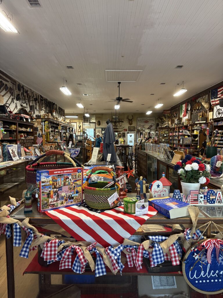 old jumbled shop with an American flag and banners in the foreground